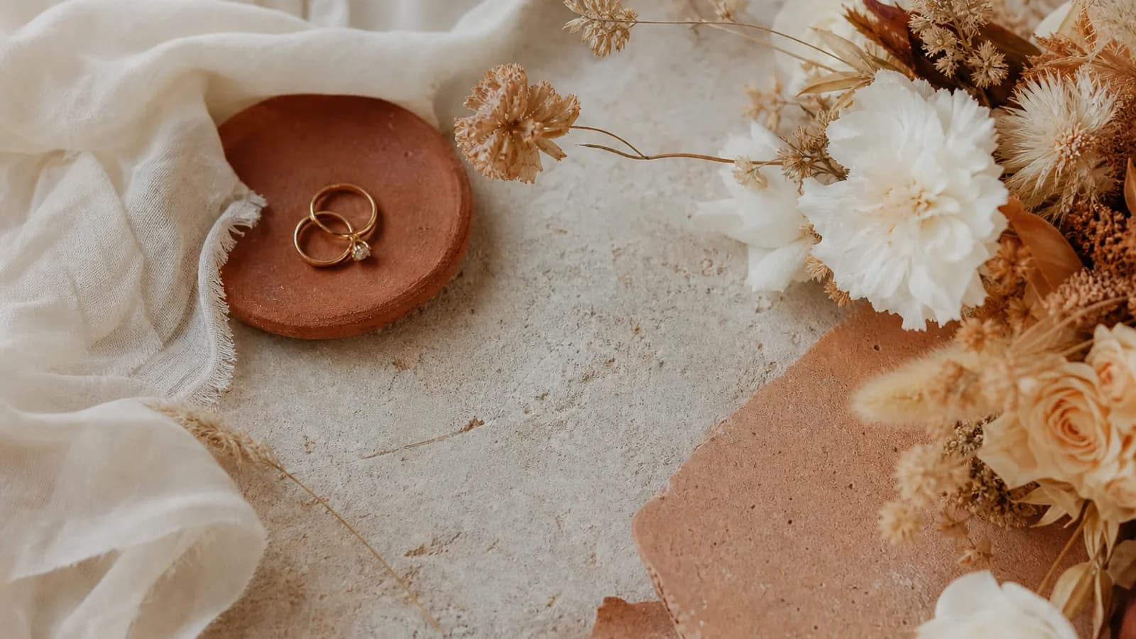 A 2026 wedding styling flat lay mixing natural texture and modern restraint